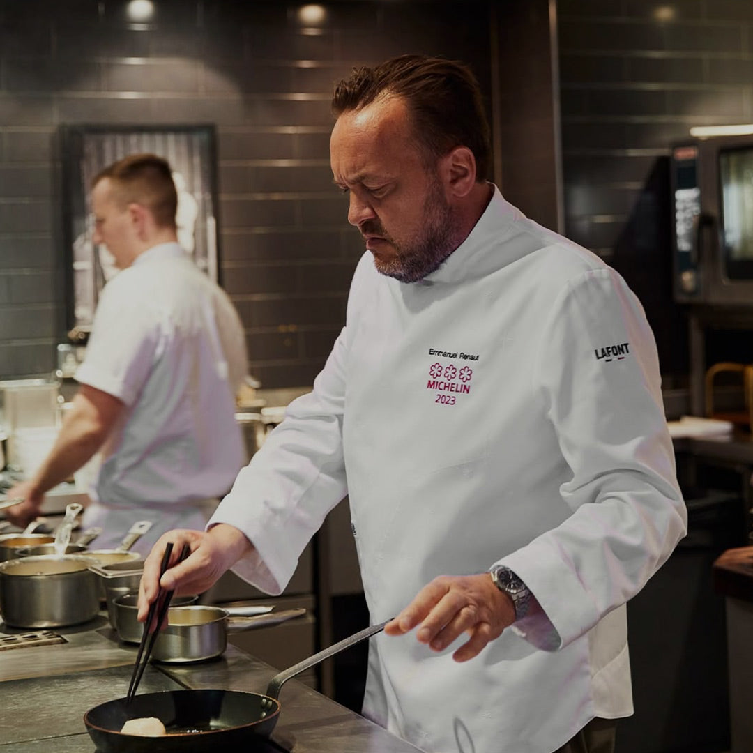 Three-star, Michelin chef in a white long sleeve coat