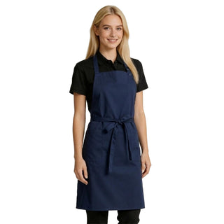 Woman wearing a navy blue bib apron with adjustable neck length and waist ties