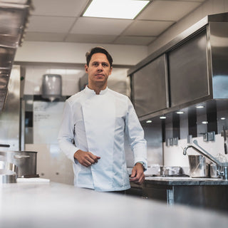 Michelin rated chef works the kitchen in a long sleeved white coat from Lafont