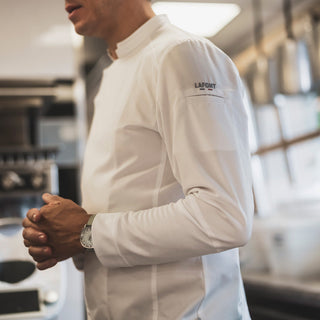 Detail of long sleeve and pin slut on a white chef coat