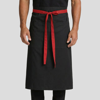Hospitality worker wearing a black apron with a red waist ties 