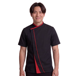 Michelin chef wearing a black chef's coat with red accents on a white background and crossover closure and hidden fastening