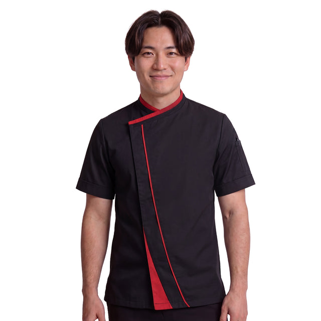 Michelin chef wearing a black chef's coat with red accents on a white background and crossover closure and hidden fastening
