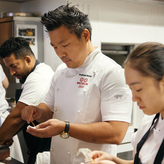 Michelin rated chef working in the kitchen wearing a Lafont Short sleeve double breasted chef jacket 